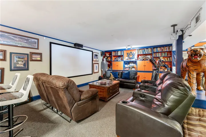 Unwind in this dedicated media room, featuring comfortable seating and a large projection screen.