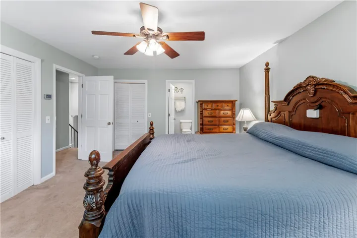 Relaxation awaits in this spacious bedroom featuring ample closet space and plush carpeting.
