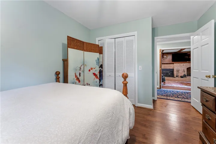 Well-appointed sleeping quarters with warm wood flooring and an adjacent sitting area.