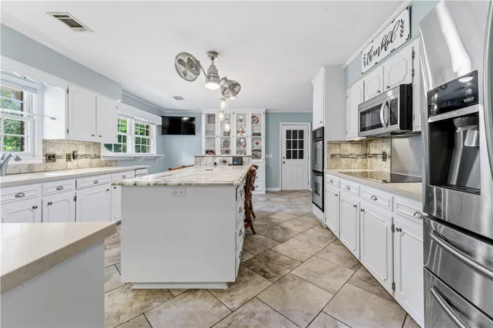 Culinary dreams come alive in this kitchen, featuring an expansive island with ample counter space.