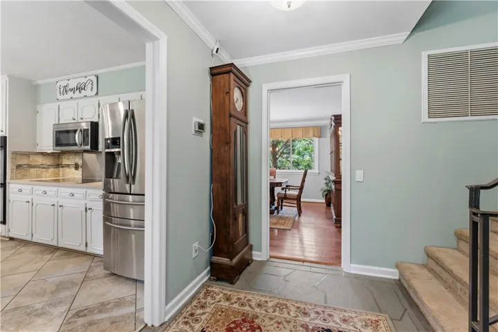 Seamless transition from a well-appointed kitchen to a dining area with scenic outdoor views.