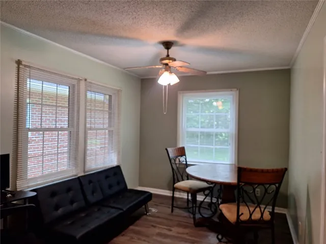 Hardwood-style flooring extends through this cozy dining area, complemented by abundant natural light.