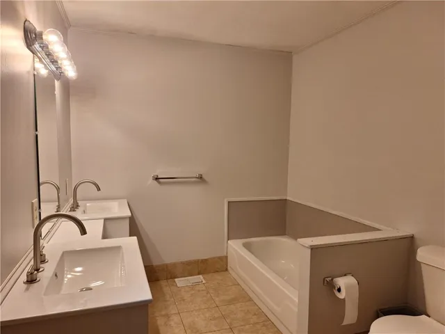 Double vanities and a bathtub create a functional, comfortable bathroom space.