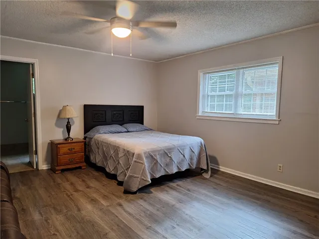 Laminate flooring adds warmth to this cozy and inviting bedroom.