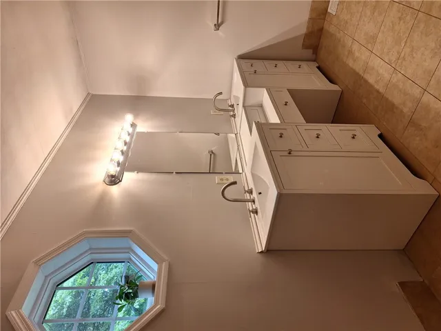 Double vanities with ample storage enhance this well-appointed bathroom.