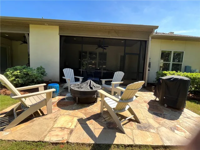 An inviting stone patio offers a cozy fire pit for outdoor gatherings.