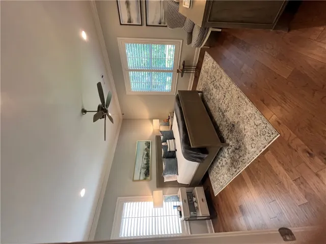 Hardwood floors and lofty vaulted ceilings create a serene and spacious bedroom retreat.