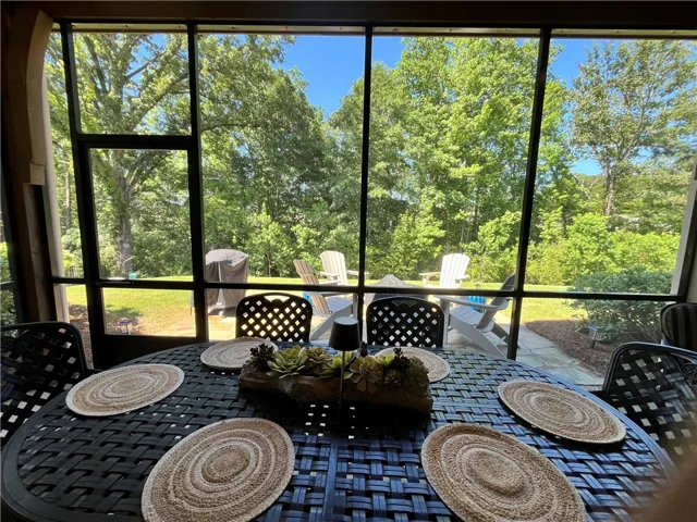 Enjoy tranquil views of the private yard from this inviting screened patio, perfect for al fresco dining.