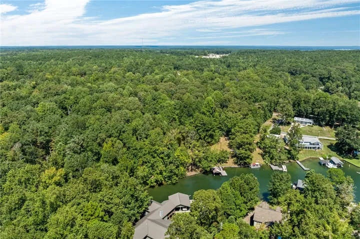 Discover a private lakefront retreat surrounded by dense forest, offering peaceful living with boat access.