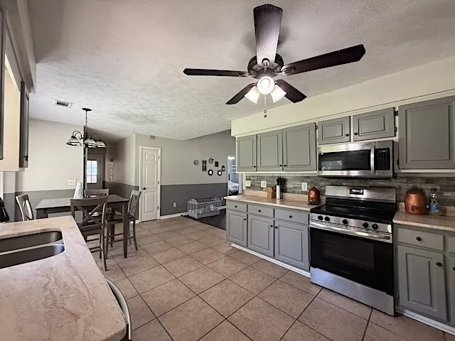 A well-equipped kitchen boasts stainless steel appliances and abundant cabinetry, perfect for culinary endeavors.