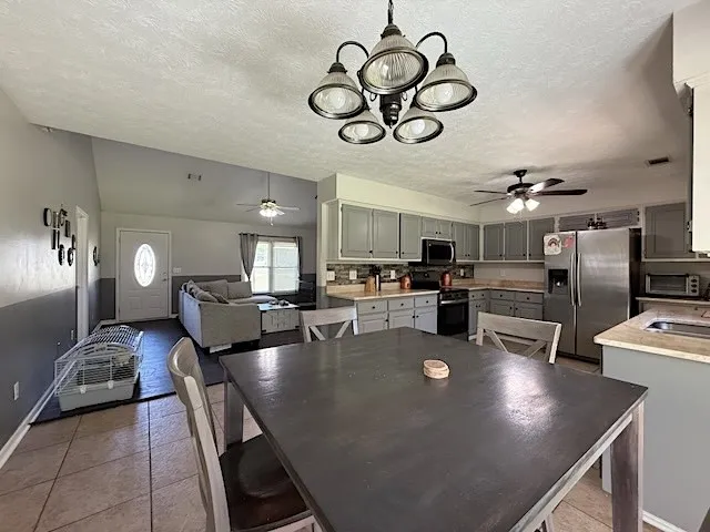 An open-concept living space integrates a well-appointed kitchen with dining and relaxation zones.