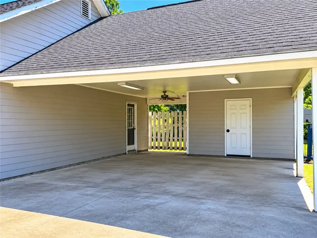 A spacious carport offers convenient, sheltered parking and direct home access.