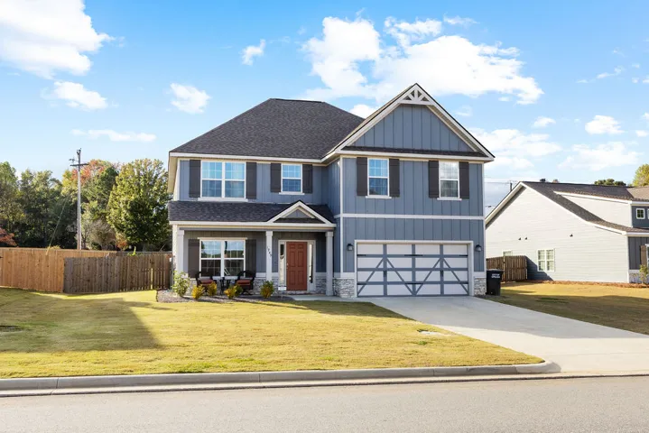 A well-maintained lawn welcomes you to this inviting two-story residence with an attached garage.