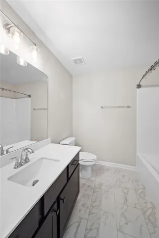White walls complement the elegant marble-look tiled flooring in this well-appointed bathroom.