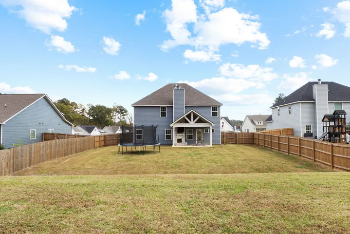 A spacious backyard with a private fence offers ample room for outdoor activities and relaxation.