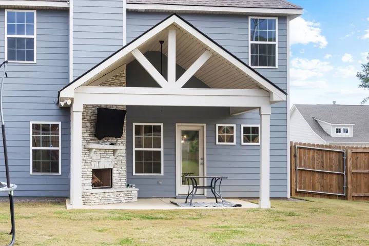 An inviting covered patio featuring an outdoor fireplace, perfect for year-round entertaining.