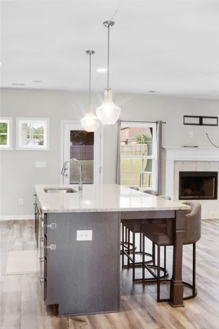 A well-appointed kitchen island with pendant lighting provides a central gathering spot.