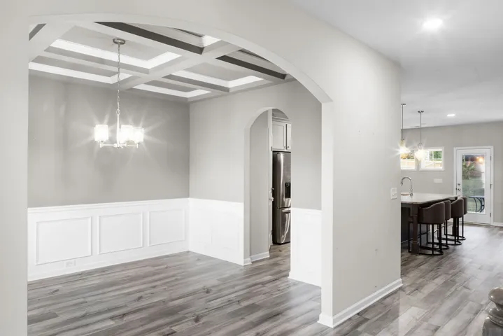 Entertaining is effortless with this dining space, complete with a statement coffered ceiling and a clear view to the kitchen.