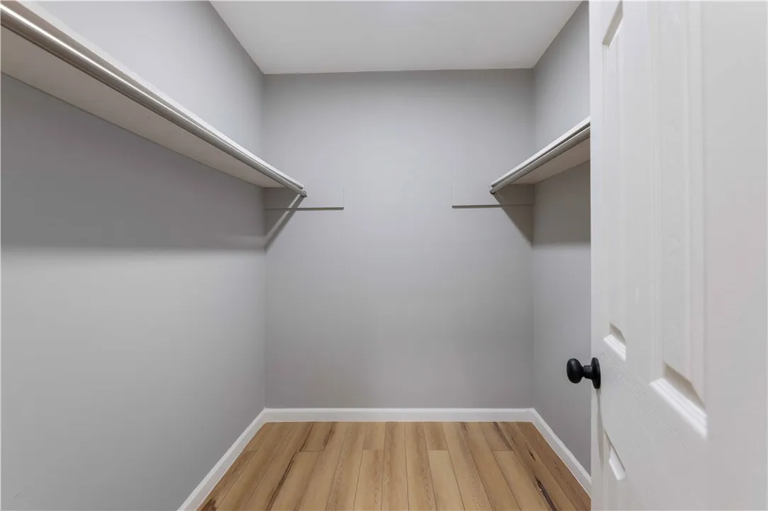 Functional shelving and hanging space in this well-appointed closet, ready for your wardrobe.