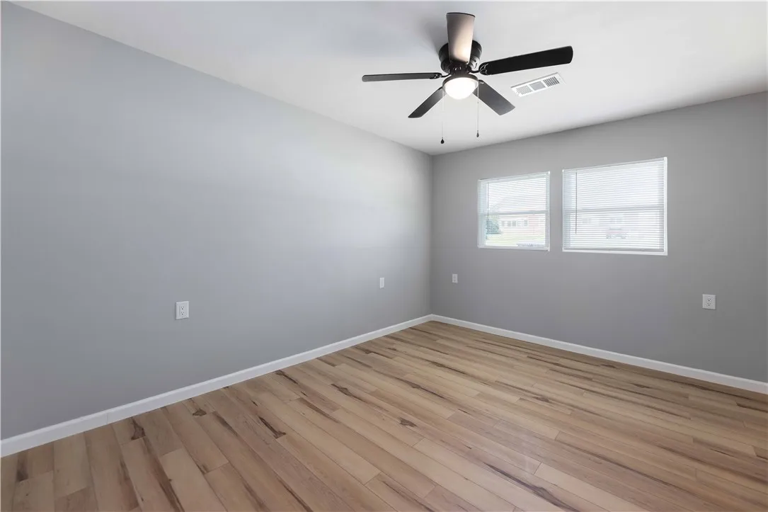 Hardwood floors and generous natural light define this inviting room.