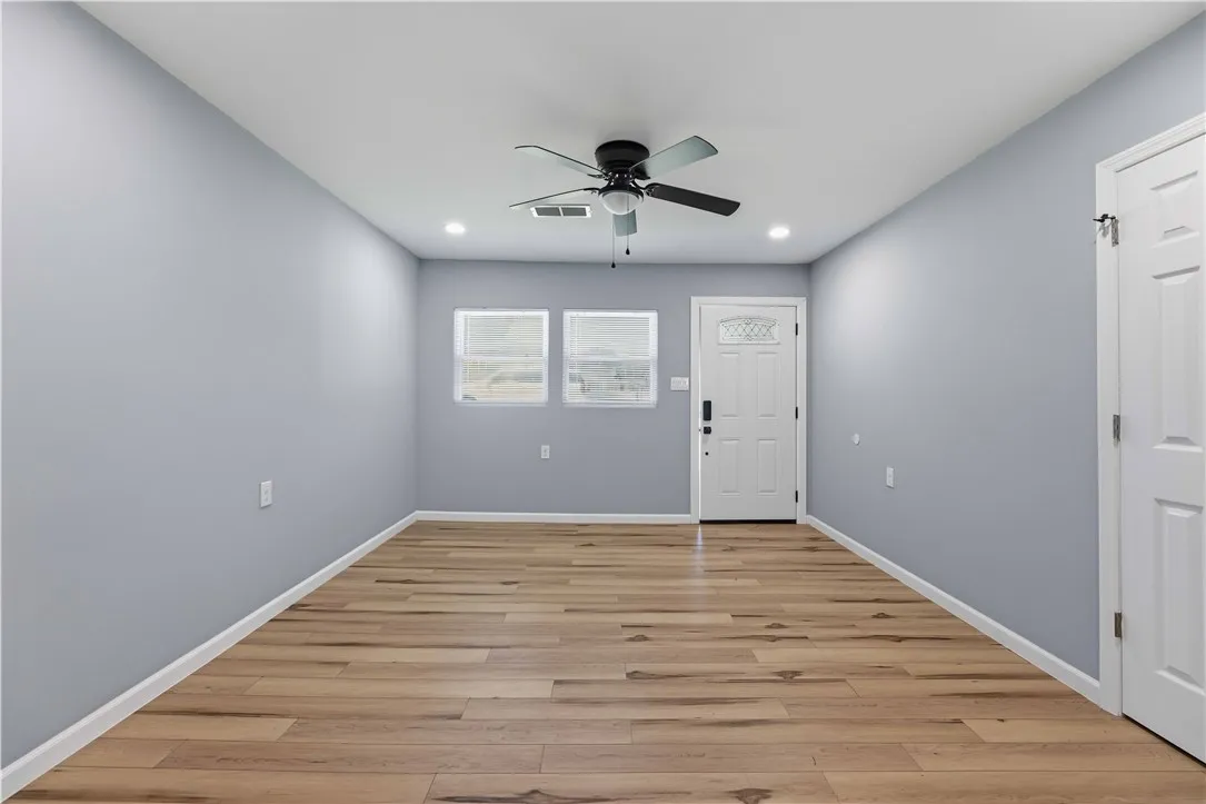 A welcoming entry features durable laminate flooring and a ceiling fan, perfect for any living space.