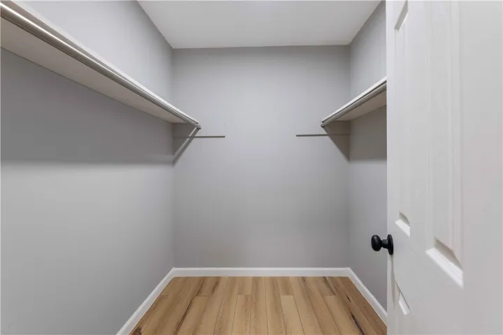 Functional shelving and hanging space in this well-appointed closet, ready for your wardrobe.