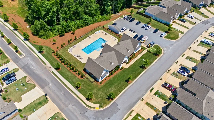 An aerial perspective reveals a vibrant community with a sparkling pool and ample green space.