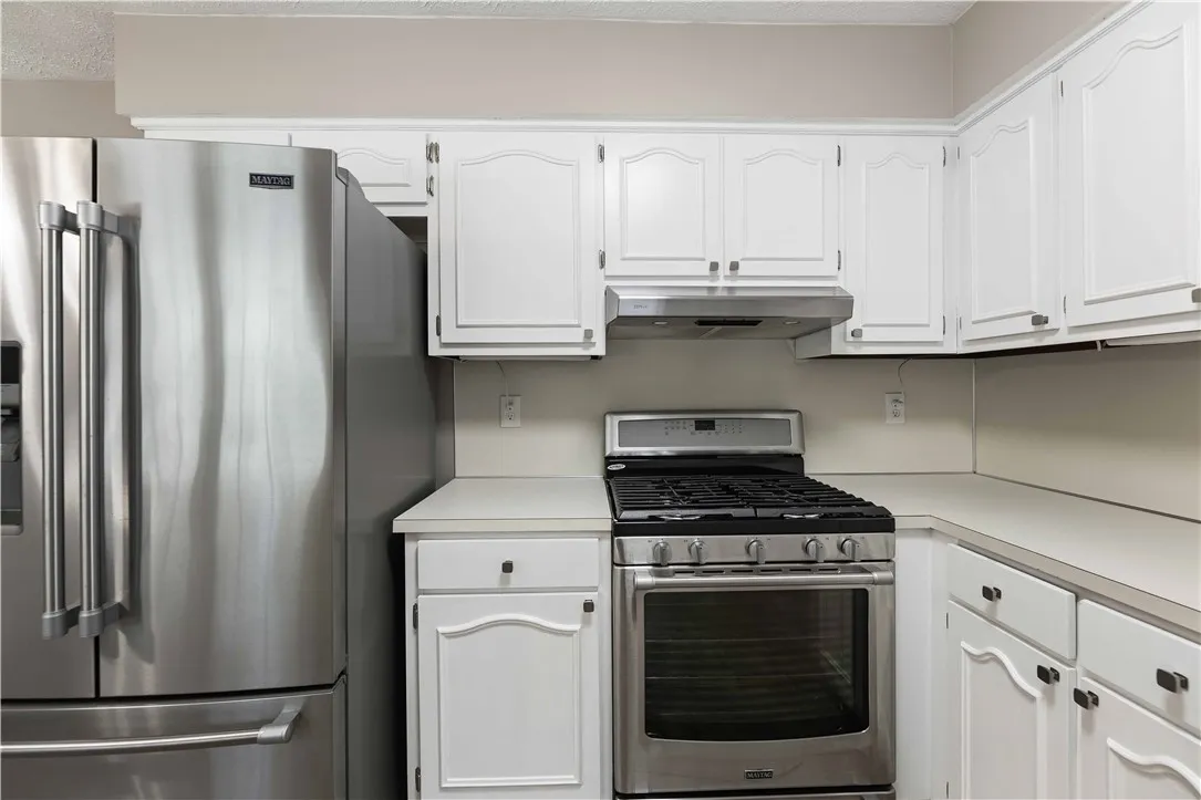 Modern kitchen equipped with sleek stainless steel appliances and ample cabinetry.