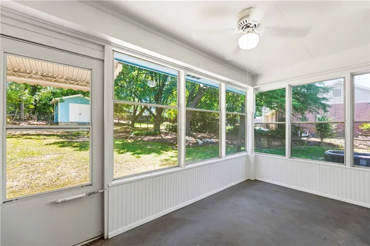 A tranquil, screened porch provides serene backyard views, perfect for relaxation.