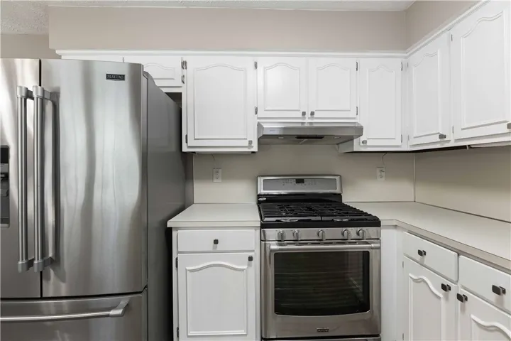 Modern kitchen equipped with sleek stainless steel appliances and ample cabinetry.