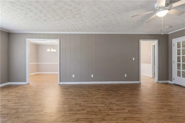 Natural wood flooring complements the serene wall paneling, setting a tranquil tone.