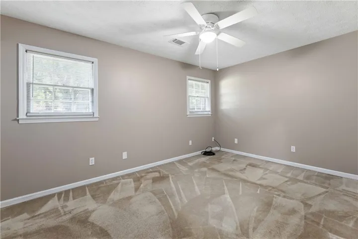 Well-lit sleeping quarters with a ceiling fan for comfort.