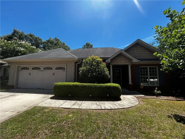 A well-maintained facade with a prominent two-car garage and inviting front entry.