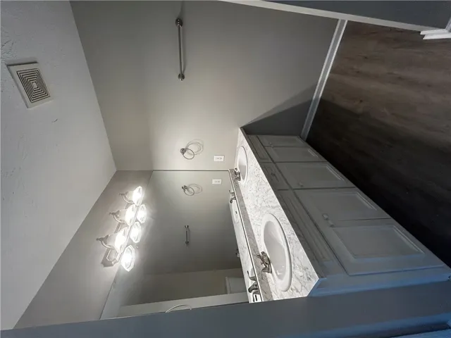 Double vanity featuring elegant marble counters provides ample space in this well-appointed bathroom.