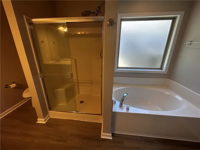 Indulge in a dedicated primary bath with a shower and a separate soaking tub for ultimate relaxation.