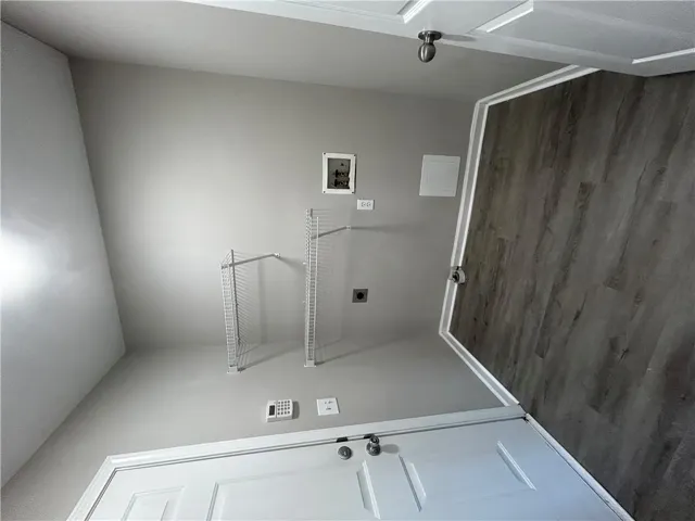 Functional laundry room offers convenient shelving and durable flooring.