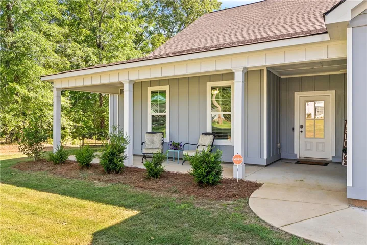 A welcoming covered front porch, perfect for enjoying quiet mornings, beckons at this charming home.