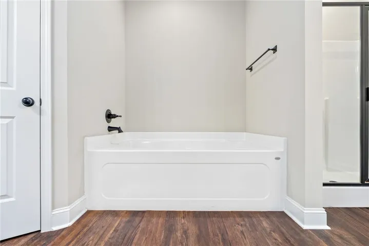 Relax in this tranquil tub, a perfect complement to the separate walk-in shower.