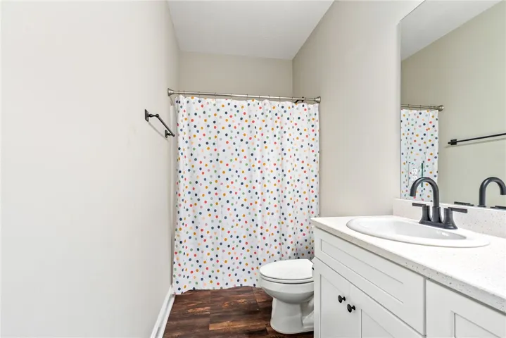 A pristine full bathroom offers both convenience and functionality.