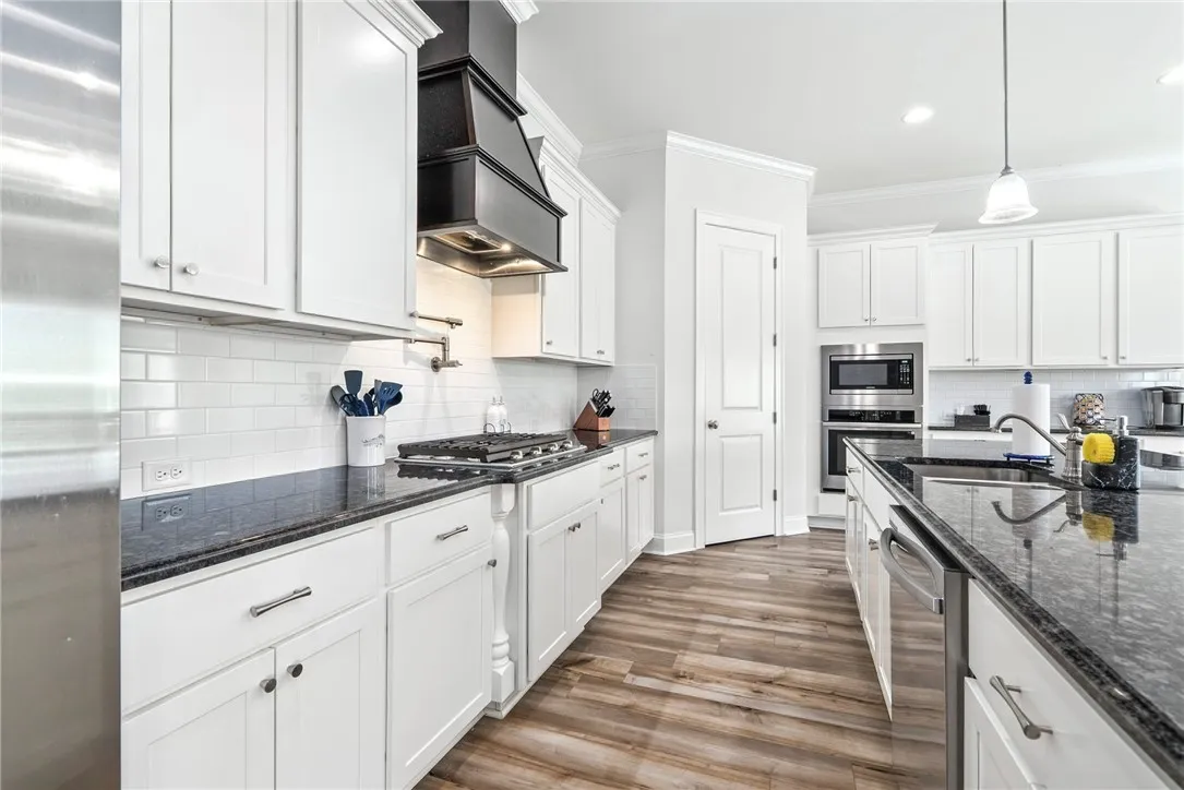 A well-appointed culinary space featuring sleek granite countertops and modern appliances for effortless meal preparation.