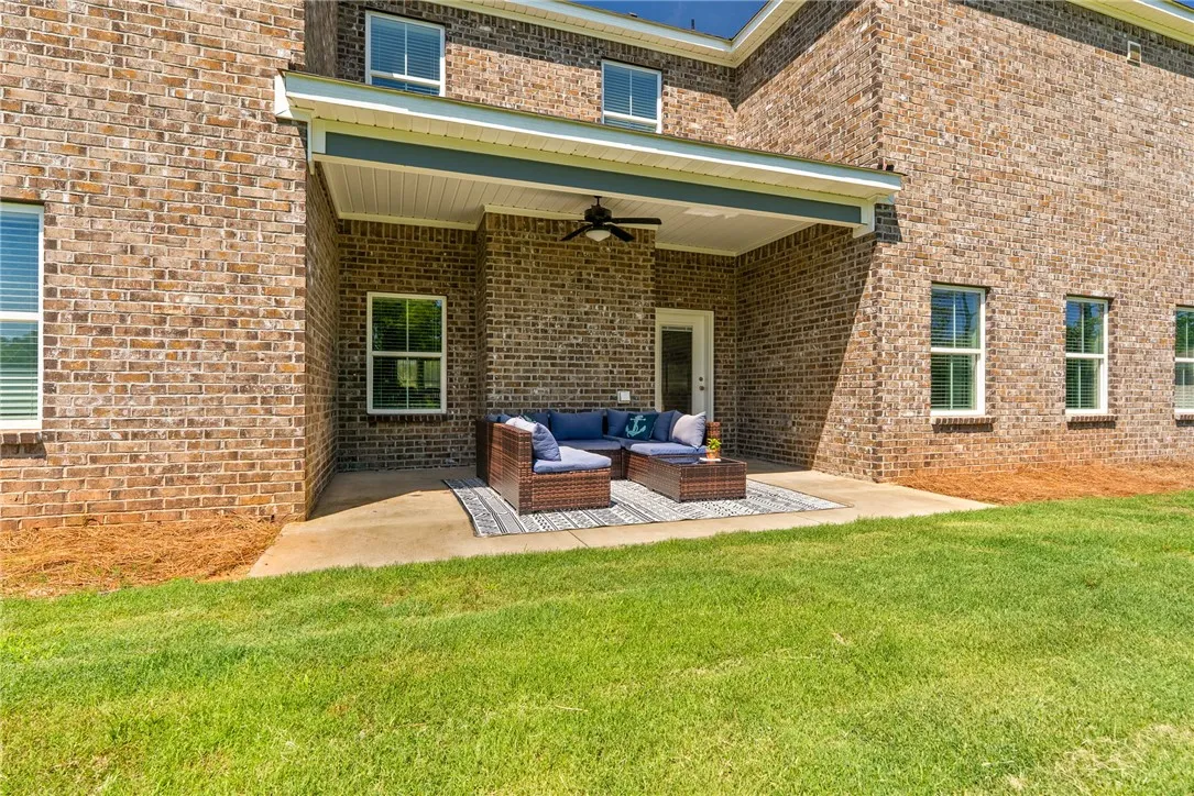 A spacious brick home features a covered patio perfect for outdoor living and entertaining.