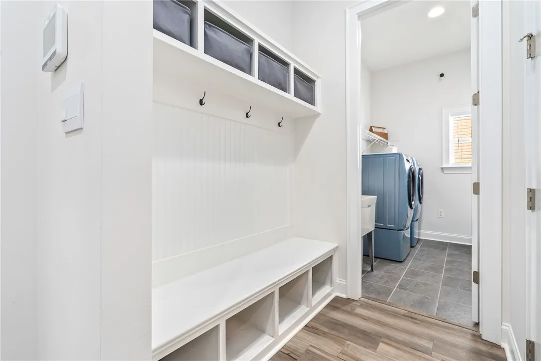 A well-appointed laundry area offers practical built-in storage solutions and durable flooring.