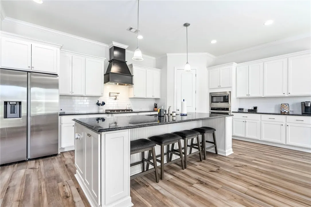 Culinary delights await in this bright, open kitchen featuring a generous island with seating.