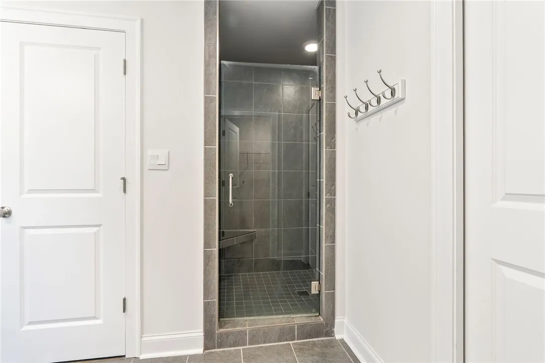A frameless glass shower enclosure creates an open, spa-like atmosphere.