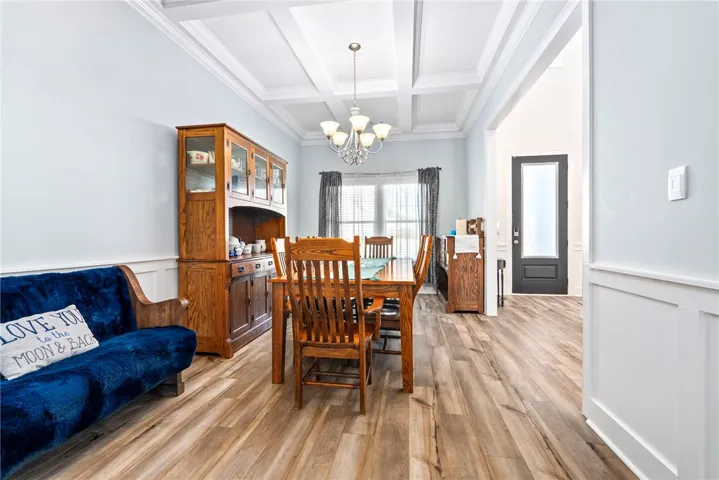 A well-appointed dining area offers ample space for gathering, complemented by the elegant tray ceiling.