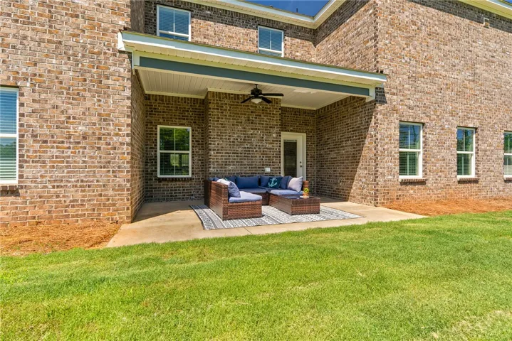 A spacious brick home features a covered patio perfect for outdoor living and entertaining.