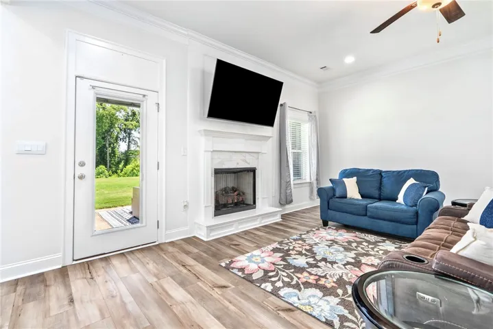 A refined fireplace and gleaming hardwood floors create an inviting atmosphere in this well-appointed living space.