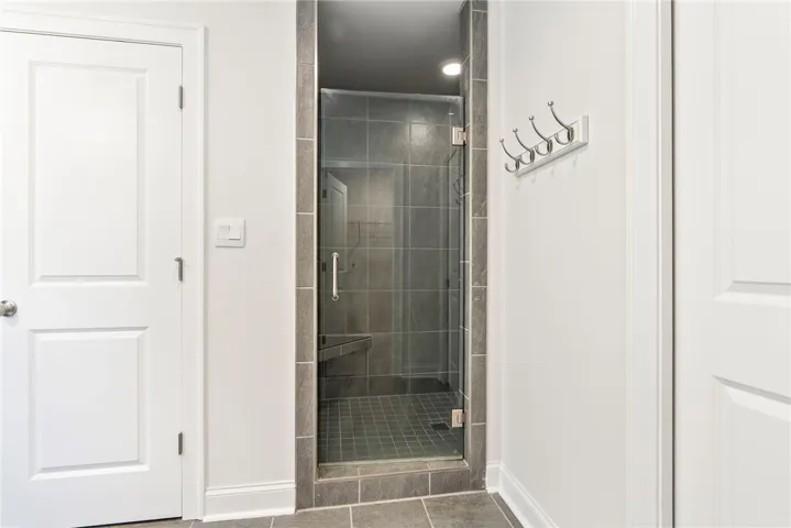 A frameless glass shower enclosure creates an open, spa-like atmosphere.