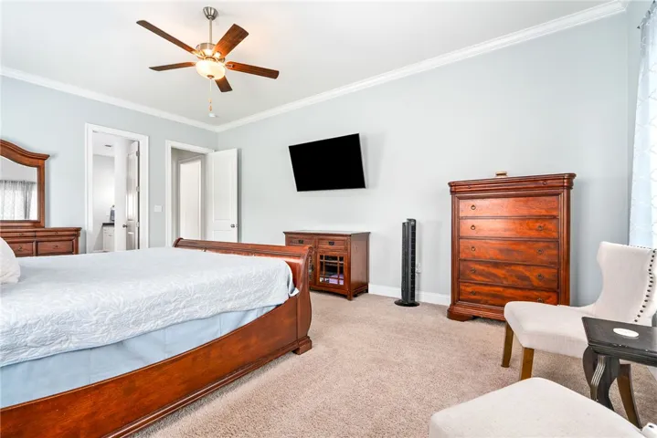 Relaxation awaits in this primary bedroom, featuring a classic ceiling fan for optimal comfort.