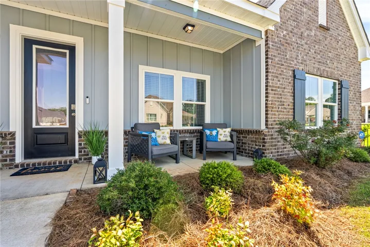 A welcoming front porch with comfortable seating, offering a pleasant spot to enjoy the outdoors.